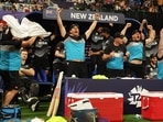 Jimmy Neesham (on left) sits quietly on his chair while New Zealand players, support staff celebrate win against England wildly