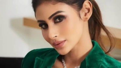 Wearing a dab of nude pink lipstick, Mouni amplified the glam quotient with rosy blushed and highlighted cheeks, smokey eyes makeup and filled-in eyebrows. The pantsuit is credited to Indian fashion designer Siddhartha Bansal's eponymous label. (Instagram/iambarkhaarora)