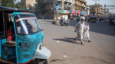 Pedestrians cross a street in Karachi, Pakistan, on Friday,&nbsp; (File Photo / Bloomberg)