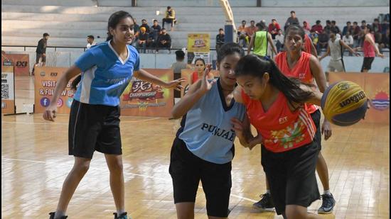 Players in action during Punjab basketball championship at Guru Nanak Stadium in Ludhiana on Saturday. (Harsimar Pal Singh/ HT)