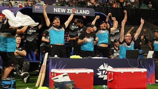 Jimmy Neesham (on left) sits quietly on his chair while New Zealand players, support staff celebrate win against England wildly Jimmy Neesham (on left) sits quietly on his chair while New Zealand players, support staff celebrate win against England wildly