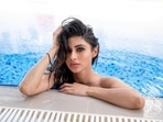 Summers might be over but Bollywood actor Mouni Roy continues to heat up things with her steamy look in a white bikini as she enjoyed a pool day this Sunday.(Instagram/imouniroy)