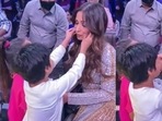 A young fan reaches out to Malaika Arora's cheeks. A young fan reaches out to Malaika Arora's cheeks. 