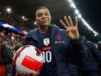 France's Kylian Mbappe gestures scoring four goals with the match ball as France qualify for the World Cup(REUTERS)
