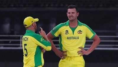 Australia's Josh Hazlewood, right, listens to captain Aaron Finch after dismissing New Zealand's captain Kane Williamson during the Cricket Twenty20 World Cup final match between New Zealand and Australia in Dubai, UAE, Sunday, Nov. 14, 2021. (AP Photo/Aijaz Rahi) (AP) Australia's Josh Hazlewood, right, listens to captain Aaron Finch after dismissing New Zealand's captain Kane Williamson during the Cricket Twenty20 World Cup final match between New Zealand and Australia in Dubai, UAE, Sunday, Nov. 14, 2021. (AP Photo/Aijaz Rahi) (AP)