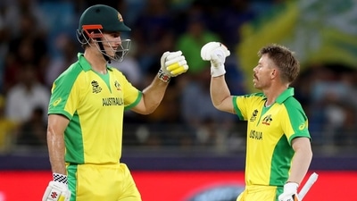 Australia's Mitchell Marsh, left, fist bumps David Warner playing without his helmet after taking it off during the Cricket Twenty20 World Cup final match between Australia and New Zealand in Dubai, UAE, Sunday, Nov. 14, 2021. (AP) Australia's Mitchell Marsh, left, fist bumps David Warner playing without his helmet after taking it off during the Cricket Twenty20 World Cup final match between Australia and New Zealand in Dubai, UAE, Sunday, Nov. 14, 2021. (AP)
