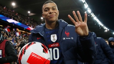 France's Kylian Mbappe gestures scoring four goals with the match ball as France qualify for the World Cup (REUTERS)