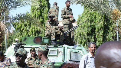 Sudanese military stand guard as military-aligned demonstrators gathered in numbers, chant "Down with the government of hunger" in front of the Presidential palace in Khartoum, Sudan on October 16, 2021. (Reuters)