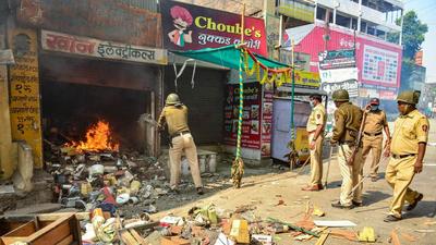 Policemen try to douse a fire in a shop, after a mob went on a rampage during a bandh allegedly organised by BJP, in Amravati, on Saturday. (PTI) Policemen try to douse a fire in a shop, after a mob went on a rampage during a bandh allegedly organised by BJP, in Amravati, on Saturday. (PTI)
