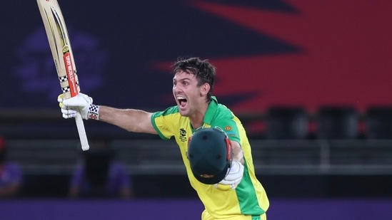 Australia's Mitchell Marsh run towards teammate Glenn Maxwell to celebrate after winning the Cricket Twenty20 World Cup final match between New Zealand and Australia in Dubai, UAE, Sunday.(AP)