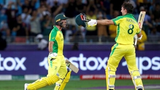 Australia's Glenn Maxwell, left, celebrates hitting a four to win the tournament, with his teammate Mitchell Marsh during the Cricket Twenty20 World Cup final match between Australia and New Zealand in Dubai, UAE, Sunday, Nov. 14, 2021. Australia won by 8 wickets. (AP)