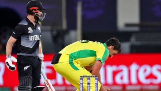 Australia's Mitchell Starc reacts after New Zealand's captain Kane Williamson, left, hit a boundary on his delivery during the Cricket Twenty20 World Cup final match between New Zealand and Australia in Dubai, UAE, Sunday, Nov. 14, 2021. (AP Photo/Aijaz Rahi)(AP)