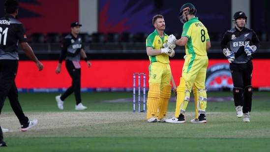 Australia's David Warner, without helmet, celebrates after hitting a six during the Cricket Twenty20 World Cup final match between New Zealand and Australia in Dubai, UAE, Sunday, Nov. 14, 2021. (AP Photo/Aijaz Rahi)(AP)