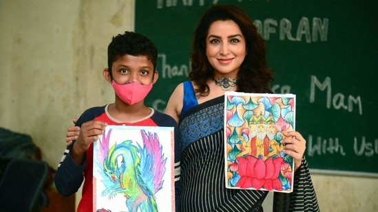 Actor Tisca Chopra poses for a picture with a boy assisted by the Salaam Balak Trust, an Indian non-profit and non-governmental organization that provides support for underprivileged children, during the launch of the 'Happy Minds' initiative by Azafran that conducts art counselling sessions, in Mumbai.(AFP)