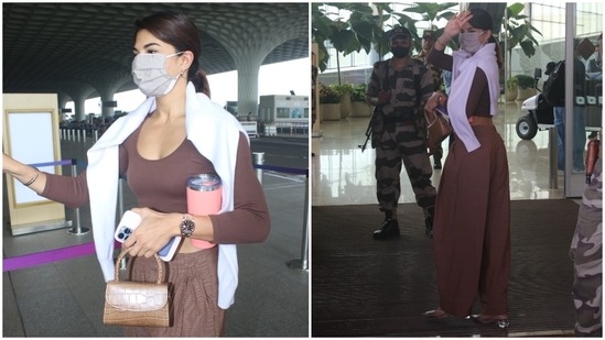 Jacqueline rounded off her airport look by layering a white knit sweater on her shoulders. She protected herself during the Covid-19 pandemic by wearing a face mask, which is also mandatory while travelling and entering the airport.(HT Photo/Varinder Chawla)