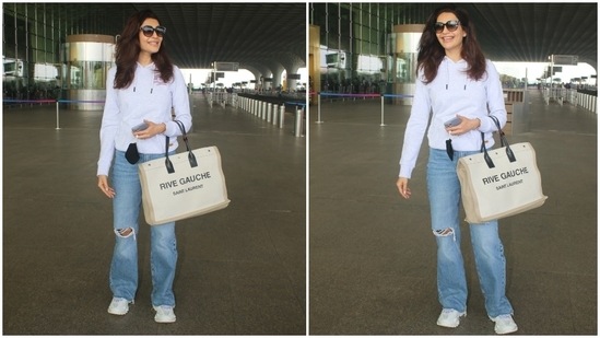 The paparazzo clicked Karishma in a simple grey sweatshirt, perfect for the fall season. The hooded top with drawstrings on the neckline featured gathered cuffs and hem.(HT Photo/Varinder Chawla)