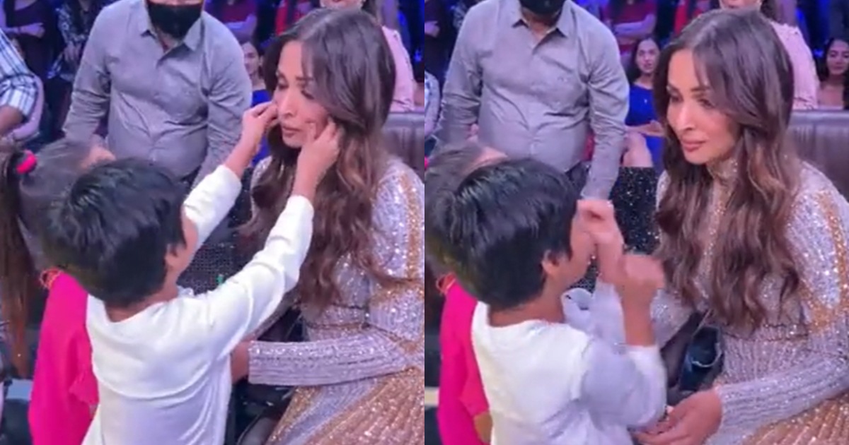 A young fan reaches out to Malaika Arora's cheeks. A young fan reaches out to Malaika Arora's cheeks. 