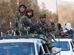 Members of Taliban sit on a military vehicle during Taliban military parade in Kabul, Afghanistan.