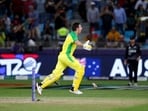 Australia's highest scorer with 77 runs Mitchell Marsh drops his bat as he celebrates after his teammate Glenn Maxwell hit a four to win the tournament in the Cricket Twenty20 World Cup final match between Australia and New Zealand in Dubai, UAE, Sunday, Nov. 14, 2021. Australia won by 8 wickets. (AP)