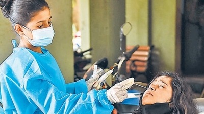 A health worker collects swab sample of a resident for a Covid-19 test in Mumbai.&nbsp; (PTI file photo)
