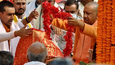 Uttar Pradesh chief minister Yogi Adityanath garlands the idol of Goddess Annapurna during its reinstallation on the Kashi Vishwanath temple premises in Varanasi on Monday. (ANI)