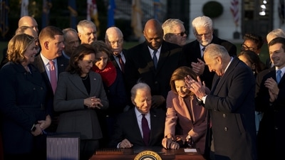 US President Joe Biden, center, signs H.R. 3684, the Infrastructure Investment and Jobs Act, during a ceremony on the South Lawn of the White House in Washington, DC. (Bloomberg) US President Joe Biden, center, signs H.R. 3684, the Infrastructure Investment and Jobs Act, during a ceremony on the South Lawn of the White House in Washington, DC. (Bloomberg)