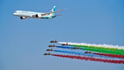 Dubai's biennial Air Show kicked off in style on November 14 at the Al Maktoum airport, a second and smaller international hub to Dubai's main airport, which is the world's busiest for international travel. In this still, an Etihad Boeing 787 Dreamliner flies alongside the Emirati Forsan military stunt flying team at the Dubai Air Show in Dubai, United Arab Emirates on November 14. (AP) Dubai's biennial Air Show kicked off in style on November 14 at the Al Maktoum airport, a second and smaller international hub to Dubai's main airport, which is the world's busiest for international travel. In this still, an Etihad Boeing 787 Dreamliner flies alongside the Emirati Forsan military stunt flying team at the Dubai Air Show in Dubai, United Arab Emirates on November 14. (AP)