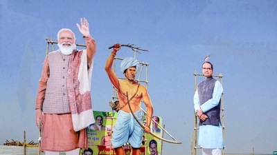 Cutouts of PM Modi, tribal leader Birsa Munda and Madhya Pradesh chief minister Shivraj Singh Chouhan are seen at Jambori Maidan in Bhopal. (PTI Photo) Cutouts of PM Modi, tribal leader Birsa Munda and Madhya Pradesh chief minister Shivraj Singh Chouhan are seen at Jambori Maidan in Bhopal. (PTI Photo)