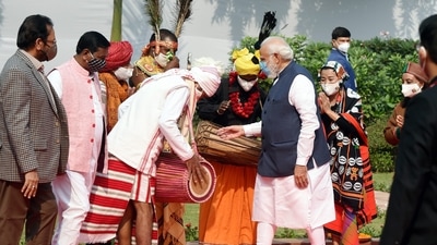 Prime Minister Narendra Modi interacts with a drummer during the ceremony. “India marks Janjatiya Gaurav Divas today. We recall the great Bhagwan Birsa Munda and reiterate our commitment to ensuring even greater progress for our tribal communities.,” PM Modi tweeted. (PTI) Prime Minister Narendra Modi interacts with a drummer during the ceremony. “India marks Janjatiya Gaurav Divas today. We recall the great Bhagwan Birsa Munda and reiterate our commitment to ensuring even greater progress for our tribal communities.,” PM Modi tweeted. (PTI)