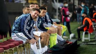 Argentina's Lionel Messi smiles as he sits on the bench during a qualifying soccer match against Uruguay' for the FIFA World Cup Qatar 2022 (AP) Argentina's Lionel Messi smiles as he sits on the bench during a qualifying soccer match against Uruguay' for the FIFA World Cup Qatar 2022 (AP)