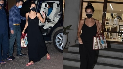 Malaika Arora was seen in a long black dress and a white bag outside her yoga studio in Mumbai Sunday evening. (Varinder Chawla) 