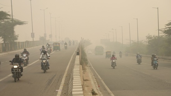 Commuters travel amidst dense smog during morning hours as pollution persists in the city, in New Delhi. (ANI)