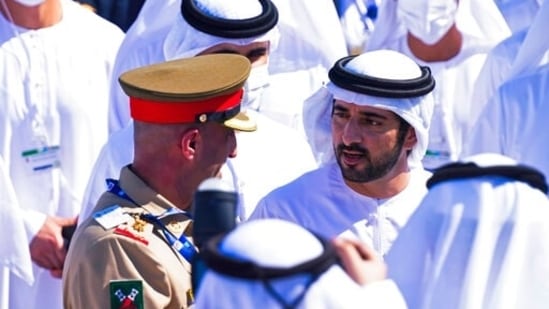 Sheikh Hamdan bin Mohammed Al Maktoum, the crown prince of Dubai, speaks to an Emirati soldier at the Dubai Air Show.(AP)