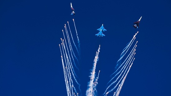 The Russian Knights perform a stunt after releasing chaff at the Dubai Air Show.(AP)