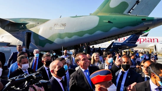 Brazilian President Jair Bolsonaro gives a thumbs up in front of a Brazilian Air Force Embraer KC-390 at the Dubai Air Show in Dubai.(AP)