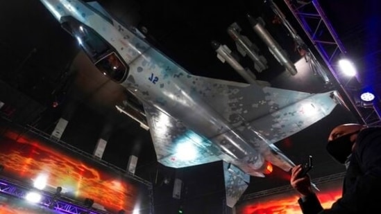 Russian officials unveil a mockup of the Sukhoi Su-75 Checkmate stealth fighter jet, a competitor to the American F-35, reflected in the ceiling, at the Dubai Air Show.(AP)