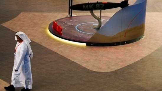 An Emirati walks past a mockup of an MK-82 bomb on display at local weapons manufacturer EDGE's stand at the Dubai Air Show on November 14.(AP)