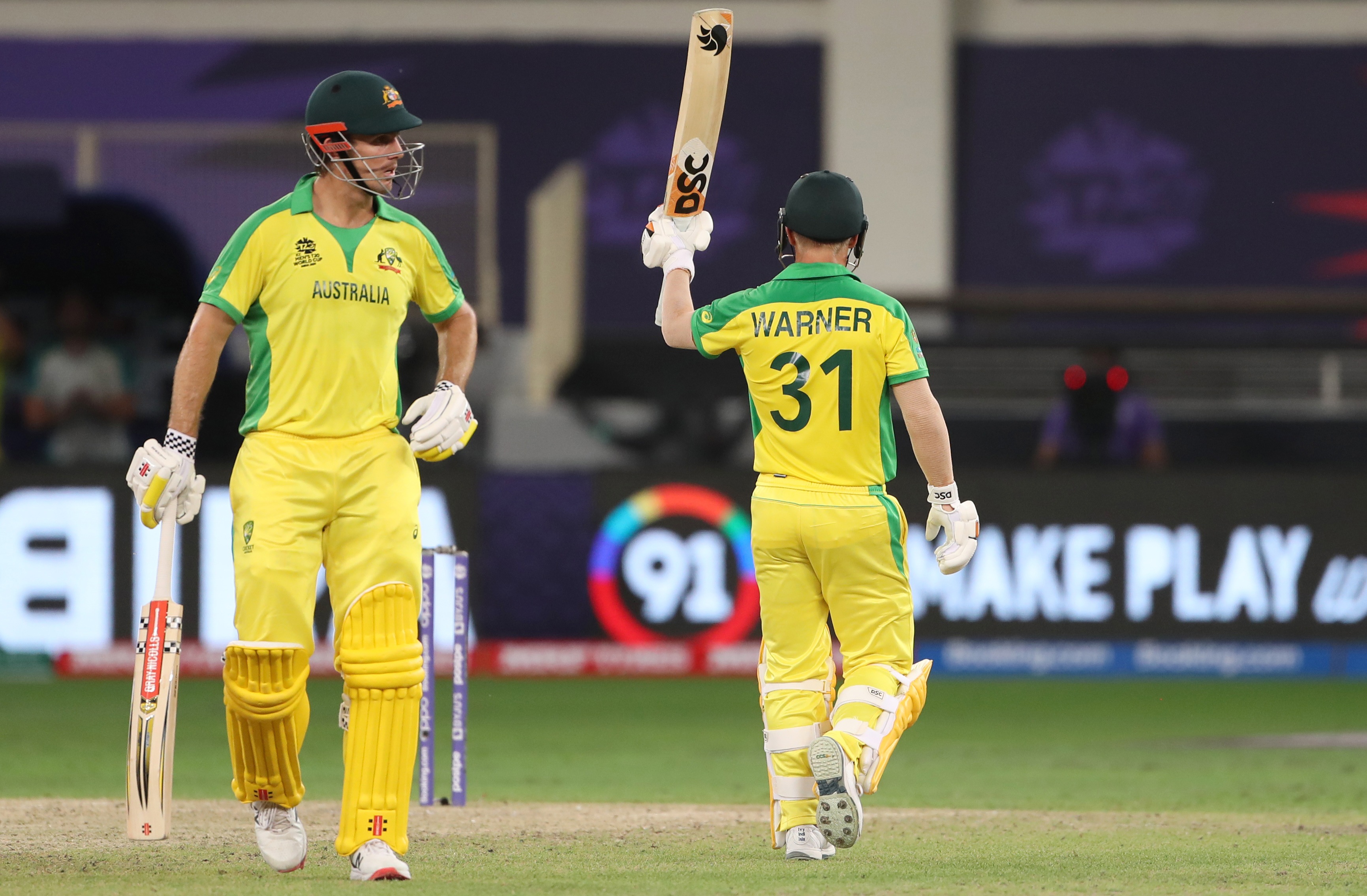 David Warner celebrates his half century during the ICC Men's T20 World Cup final match between New Zealand and Australia, at Dubai International Stadium in Dubai on Sunday. (ANI)