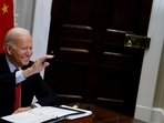 US President Joe Biden waves to Chinese leader Xi Jinping as they begin a virtual meeting from the White House in Washington, U.S.