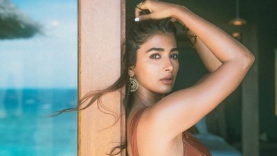 Sharing a picture in a brown monokini, Pooja wrote, “Biscuit dipped in caramel and covered in chocolate… basically I’m a bar of Twix?!” (Instagram) Sharing a picture in a brown monokini, Pooja wrote, “Biscuit dipped in caramel and covered in chocolate… basically I’m a bar of Twix?!” (Instagram)