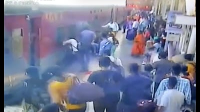 Screenshot of the incident at the Kalyan railway station in which a pointsman saves the life of a man by pulling him up between train and platform. (HT PHOTO)