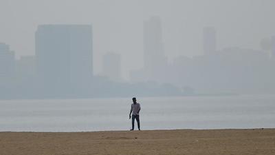 A person on Chowpatty beach in Mumbai on Tuesday. The city’s air quality on the AQI scale worsened on Tuesday to 280, putting it in the ‘poor’ category. (AFP) A person on Chowpatty beach in Mumbai on Tuesday. The city’s air quality on the AQI scale worsened on Tuesday to 280, putting it in the ‘poor’ category. (AFP)
