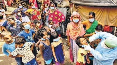 A healthcare worker collects swab samples of underprivileged children for Covid-19 test in Kolkata. (ANI ) A healthcare worker collects swab samples of underprivileged children for Covid-19 test in Kolkata. (ANI )