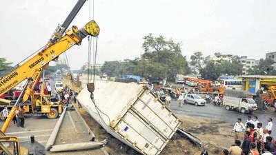 Vehicular movement on the Katraj-Dehu road bypass in Pune was disrupted for nearly two hours during peak traffic hours on Tuesday, after a truck flipped onto its side near Navale bridge. (HT)