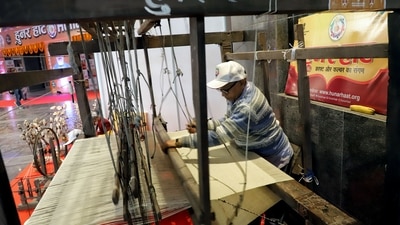 A man weaves inside a stall during inauguration of the 33rd Hunar Haat at the 40th India International Trade Fair at Pragati Maidan in New Delhi. (ANI) A man weaves inside a stall during inauguration of the 33rd Hunar Haat at the 40th India International Trade Fair at Pragati Maidan in New Delhi. (ANI)