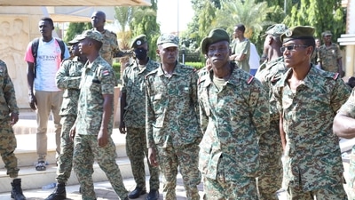 Sudanese authorities have not commented on the reporter's detention. In picture - Sudanese military stand guard as military-aligned demonstrators gathered in numbers in front of the Presidential palace in Khartoum, Sudan. (Reuters)