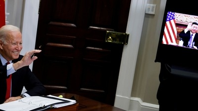 US President Joe Biden waves to Chinese leader Xi Jinping as they begin a virtual meeting from the White House in Washington, U.S. (REUTERS)