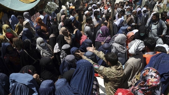 Internally displaced Afghans from northern provinces, who fled their home due to fighting between the Taliban and Afghan security personnel, wait to receive free food in a public park in Kabul, Afghanistan.(AP | Representational Image)