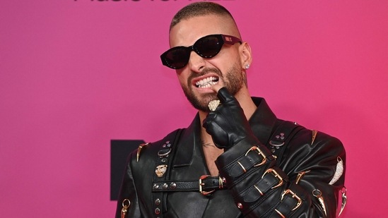 Colombian singer Maluma gives offrockstar vibes as he arrives at the red carpet dressed in a stylish leather jacket.(AFP)