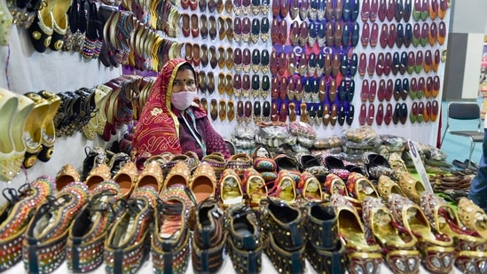 A women sits at her stall waiting for customers at the India International Trade Fair (IIFT) 2021 in New Delhi.(PTI)
